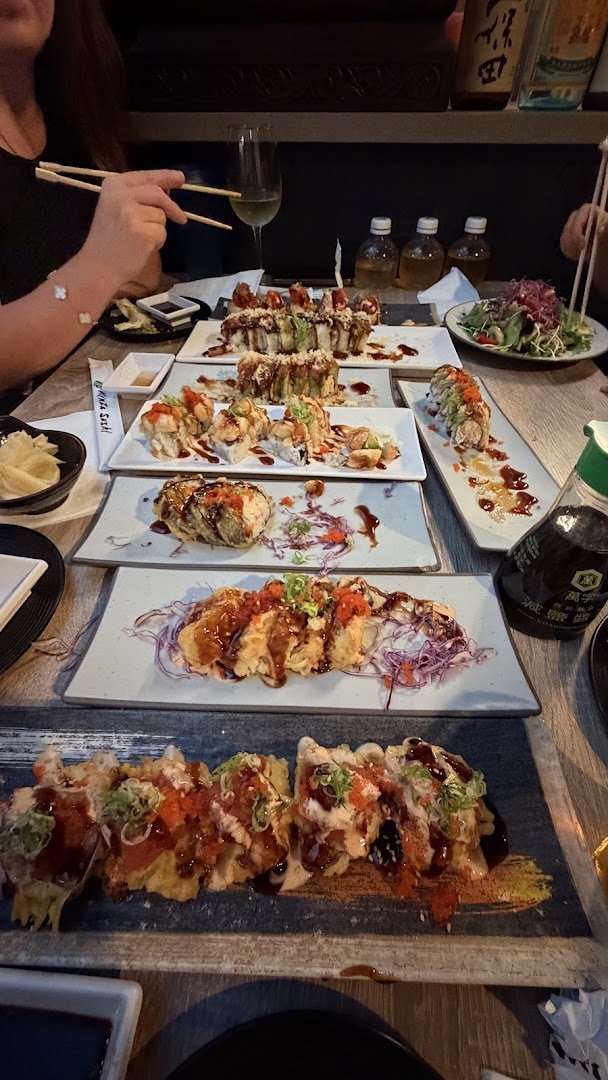 Bar seating inside a casual Japanese restaurant.